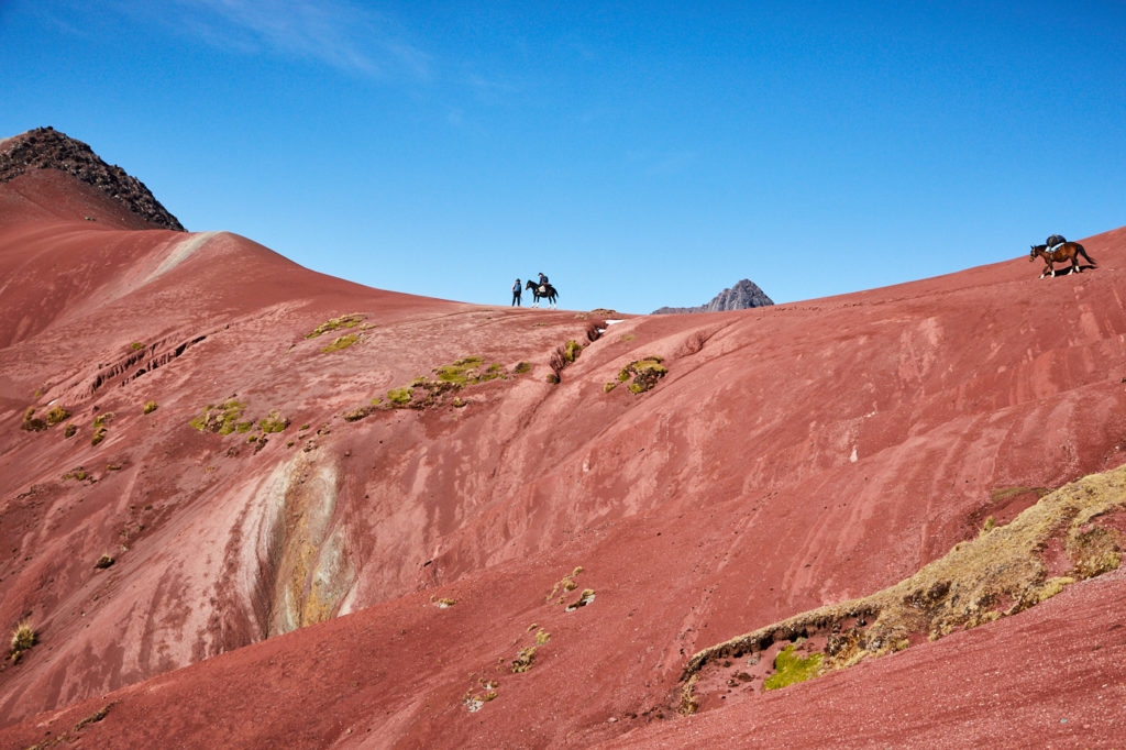 If the height causes some trouble you can also take a ride on the safety horse like my friend did – she’s standing on top of a fiery red mountain in the Red Valley of Peru